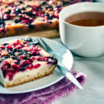 Tasty breakfast. Delicious pie with assorted berries and cottage cheese and a cup of tea