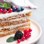Tasty cake with berries on grey table, closeup